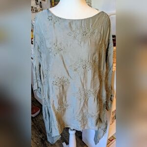 Light, breezy sage green blouse with a graceful silhouette. Sleeveless blouse